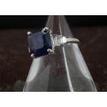 A modern sapphire and diamond cocktail dress ring, the 18ct white gold mount with large blue