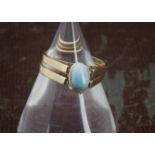 An African 14ct gold day and night ring, the two bands with hinged oval tablet having blue larimar