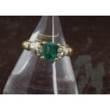 A modern and pretty emerald and diamond ring, the square cut 1ct emerald probably Columbian, in an