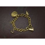 A Victorian 18ct gold bracelet, the heavy curb link chain with a heart shaped clasp, mounted with