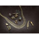 A collection of 9ct gold and yellow metal jewellery, including a Cleopatra style fringe necklace,