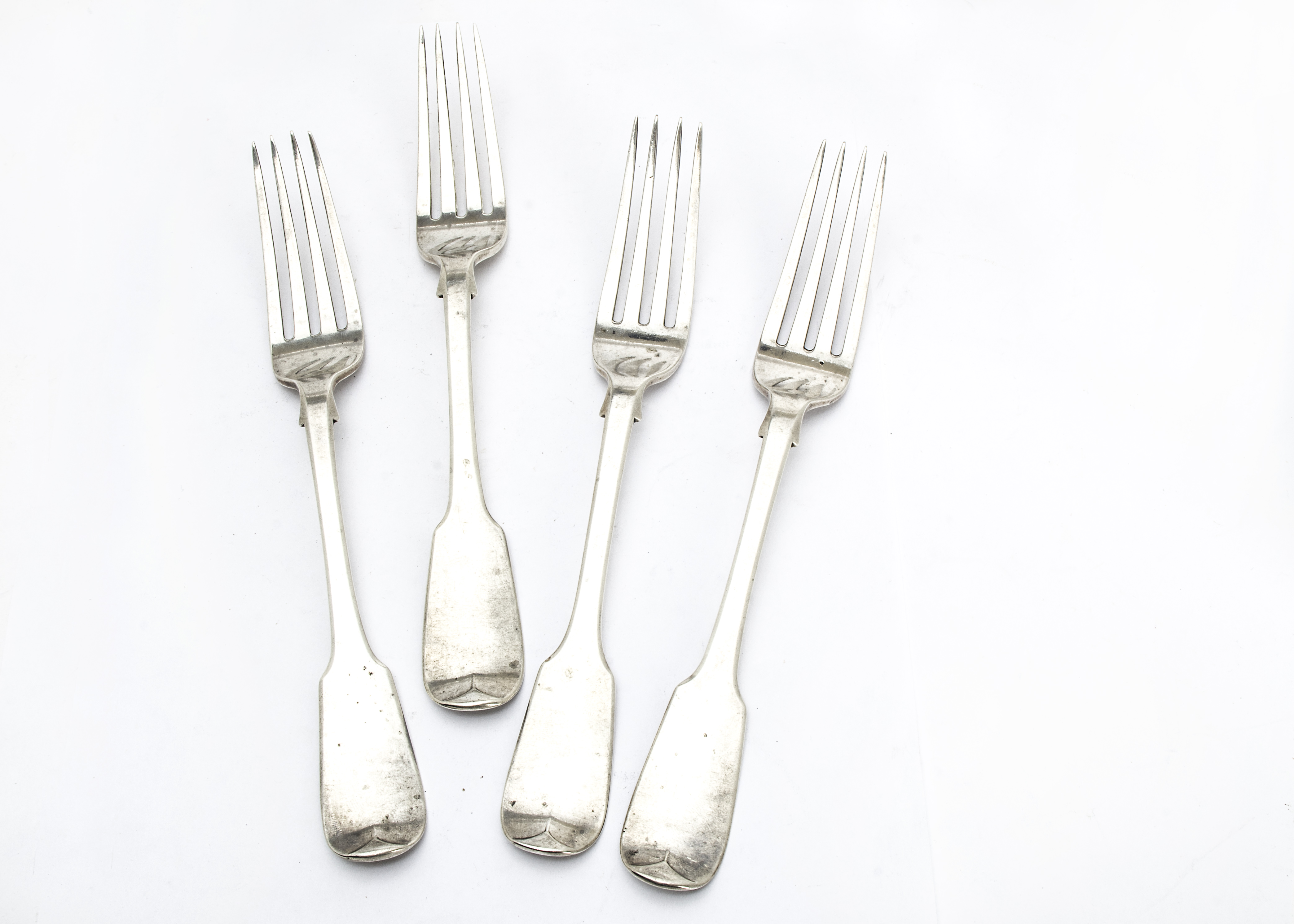 A set of four Victorian silver dinner forks by George Adams, fiddle pattern, three dated London