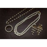 Four items of cultured pearl jewellery, including a pair of chandelier earrings, a twin strand