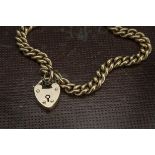 A late Victorian 9ct gold bracelet, the hallmarked curb link chain with thin safety chain and