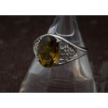 A modern 9ct white gold and chrysolberyl dress ring, oval light brown stone with mount having