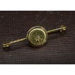 A Victorian 9ct gold and diamond brooch, the circular panel centred by an old cut on a bar pin, 4.7g