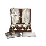 Two George V silver cigarette cases, together with a pair of silver napkin rings, 12 ozt, and a