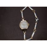 An Art Deco 9ct gold cased lady's wristwatch, on a 9ct white and rose gold bracelet, with spare