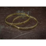 A pair of 14ct gold bangles, with Greek key pierced design, 9.7g (2)