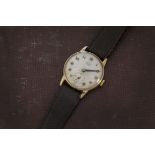 A 1960s 9ct gold Smiths De Luxe gentleman's wristwatch, circular case with silver dial having