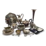 A collection of silver plated items, including a large trumpet vase, two teasets, cake stand,
