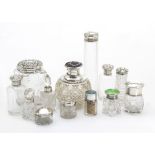 A collection of cut glass and silver capped dressing table items, various scent bottles and jars
