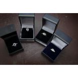 Four modern 9ct white gold and gem set items of jewellery, including three rings and a pendant, each