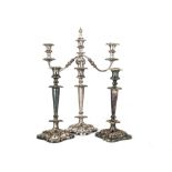 An Edwardian period Sheffield plate candleabra set, comprinsing a pair of single candlesticks and