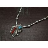 A vintage Mexican silver necklace, with abstract pendant set with turquoise and coral, marked JJ and