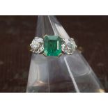 A good three stone emerald and diamond ring, the 18ct gold mount having a pair of old cuts of approx