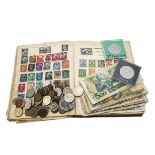 A collection of various coins and bank notes and stamps, mostly tourist loose change and notes,