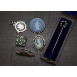 A cased Victorian stick pin, having pearl horseshoe, together with a trench art sweetheart brooch,