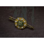 A vintage Middle Eastern emerald and pearl brooch, the bar brooch mount having a cluster of pearls