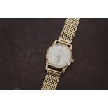 A 1950s 9ct gold Longines automatic gentleman's wristwatch, circular case, silver dial with