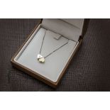 A modern 9ct gold double heart pendant, set with a small diamond and on fine chain, together with