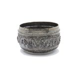 A large 19th century Indian silver bowl, having intricate embossed scenes of figures with ornate