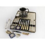 A collection of silver plated flatware and other items, including a silver Churchill medallion in