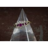 A 9ct gold ruby and diamond cluster style ring, lacking a brilliant cut, 2.4g and size L