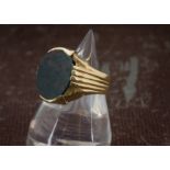 A vintage Middle Eastern gold and bloodstone gentleman's signet ring, the large oval panel in