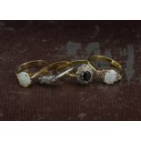 A group of four gold and gem set rings, two with opals and marked 14ct, an Art Deco three stone