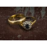 A 22ct gold wedding band, 3.6g, together with an 18ct gold sapphire and diamond cluster ring, 3.