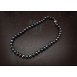 A modern pearl necklace, with cultured black pearls and white 9ct gold ovoid ball clasp, 20cm closed