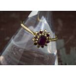 An 18ct gold ruby and diamond cluster ring, 1.9g and size O