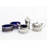 An Art Deco silver three piece cruet set by ALD, together with a pair of silver and blue glass