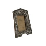 An Edwardian silver mounted photograph frame by James Dixon & Sons, having raised design of lady and