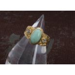 A Victorian gold turquoise and diamond three stone ring, the thick tapering band engraved to