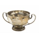 A large 1960s silver presentation cup, the circular spreading foot below wide bowl and having ear