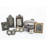 A small silver photograph frame, together with a pair of Middle Eastern white metal photograph