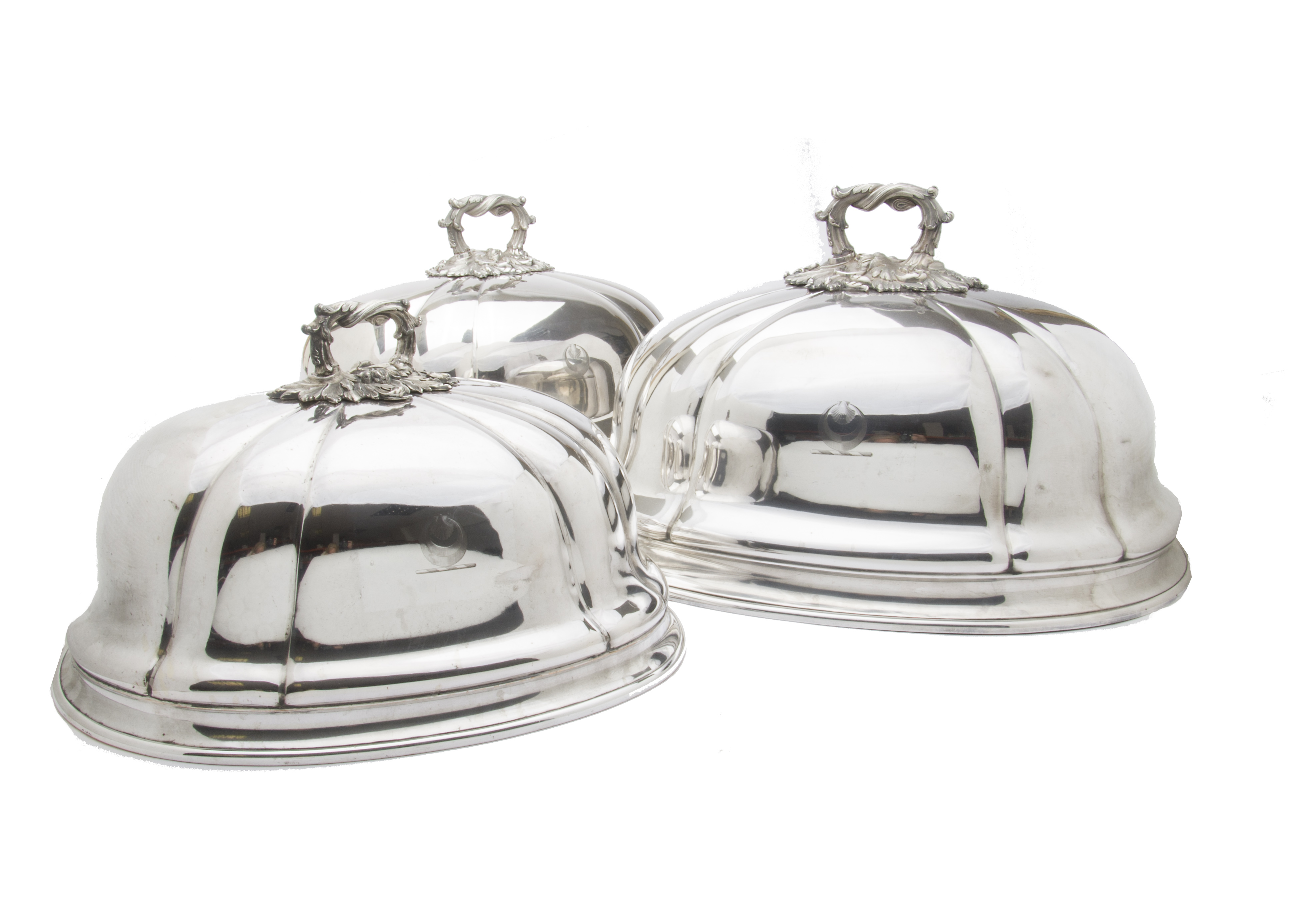 A fine set of three Victorian silver plated meat covers, the graduating domes with applied ornate