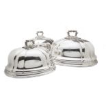 A fine set of three Victorian silver plated meat covers, the graduating domes with applied ornate