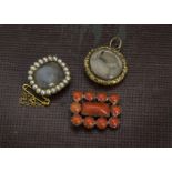 Two 19th century items of mourning jewellery, a circular pendant and a small brooch, together with a