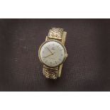 A 1960s 9ct gold tudor gentleman's wristwatch, cream coloured dial with batons and partial numerals,