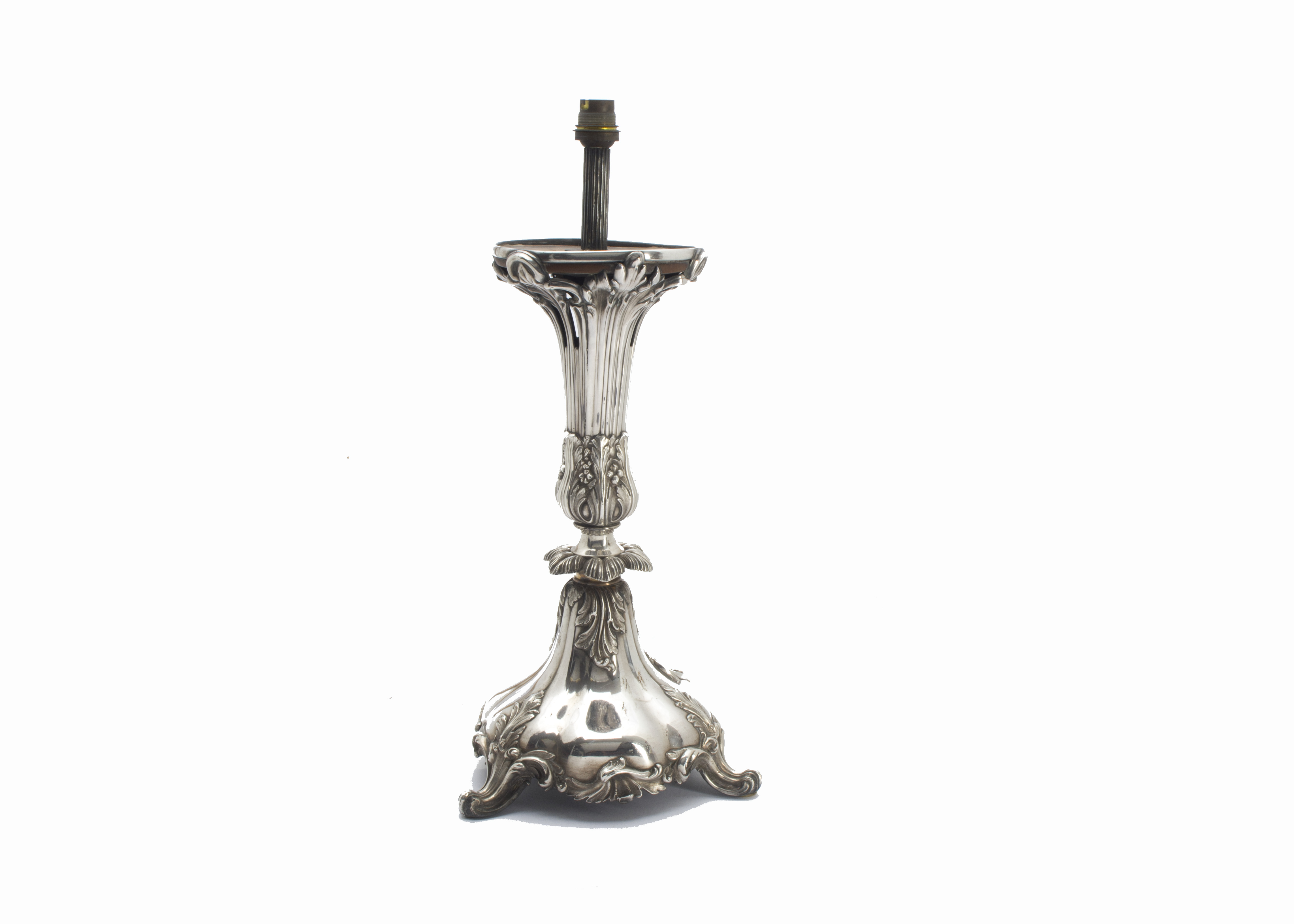 A Victorian silver table lamp base, the rococo themed base with three supports and decorated with