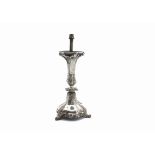 A Victorian silver table lamp base, the rococo themed base with three supports and decorated with