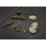 A small group of gold and yellow metal jewellery, including a heavy brooch, further three
