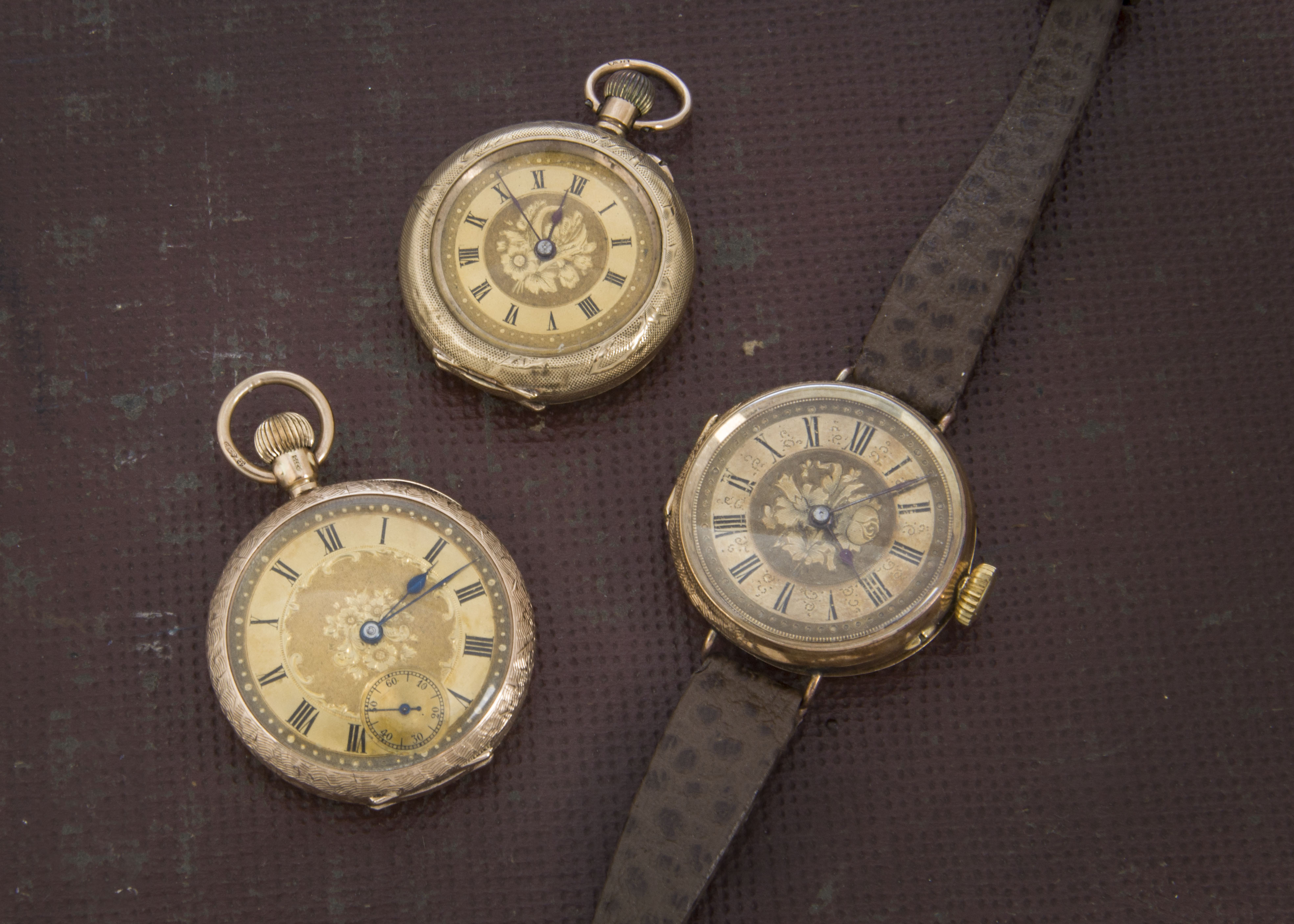 A group of three late 19th and early 20th century gold ladies pocket watches, one marked 14k with