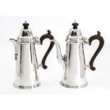 A pair of modern silver café au lait pots from Mappin & Webb, the coffee and hot milk pots of
