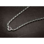 A modern 18ct white gold necklace, having a cluster to the fringe with a round cut ruby in brilliant