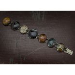 A Victorian silver and hardstone bracelet, the seven oval polished specimen agates and hardstones in