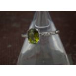 A modern 9ct white gold cuprian tourmaline ring, heightened with diamond set shoulders, 2g and